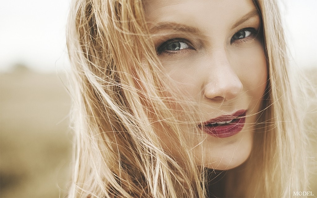 Model with flowing hair and natural makeup.