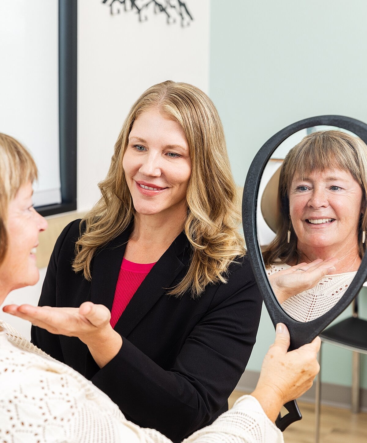 Modern seating area with blue chairs and greenery.