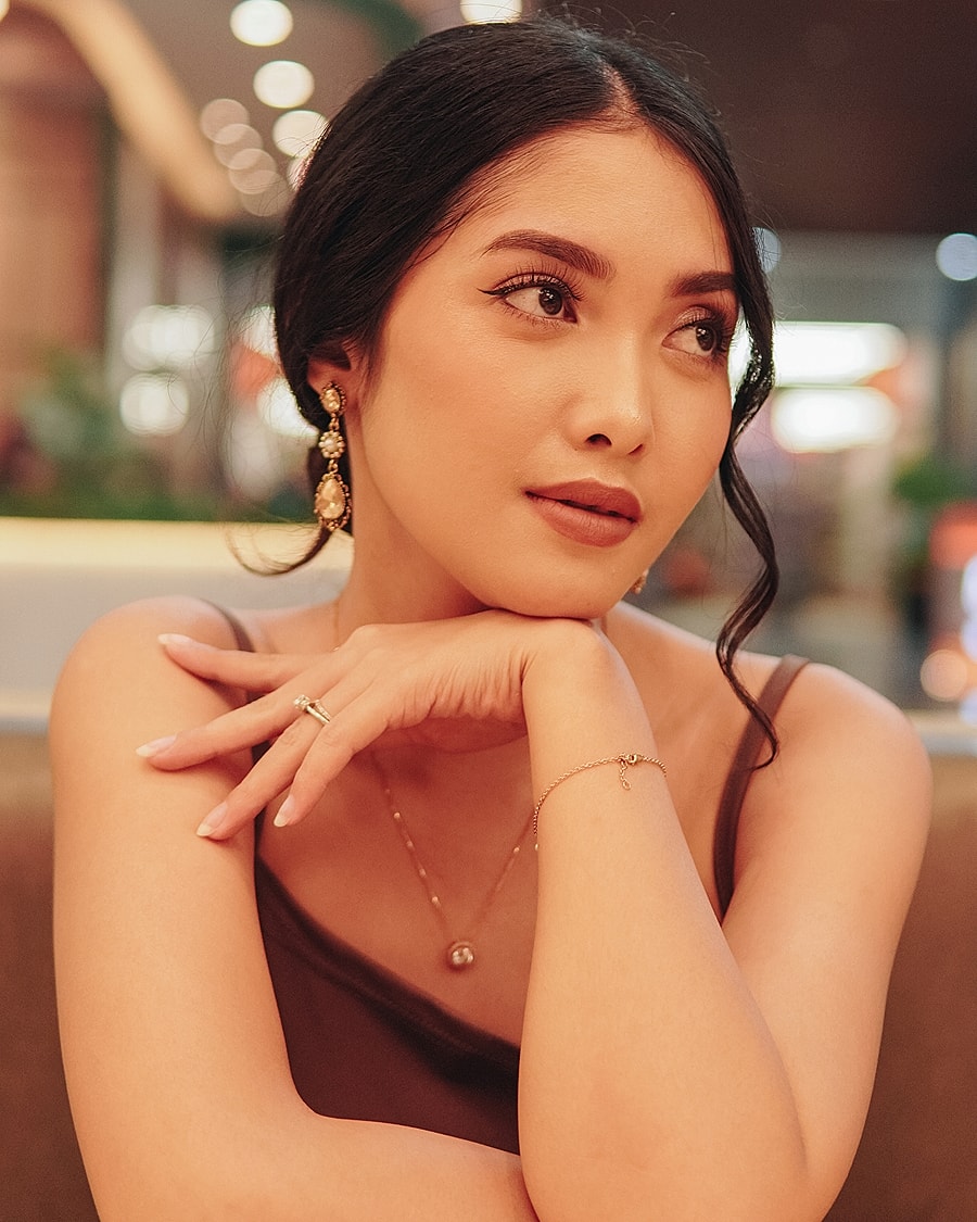 Model posing in black athletic wear.