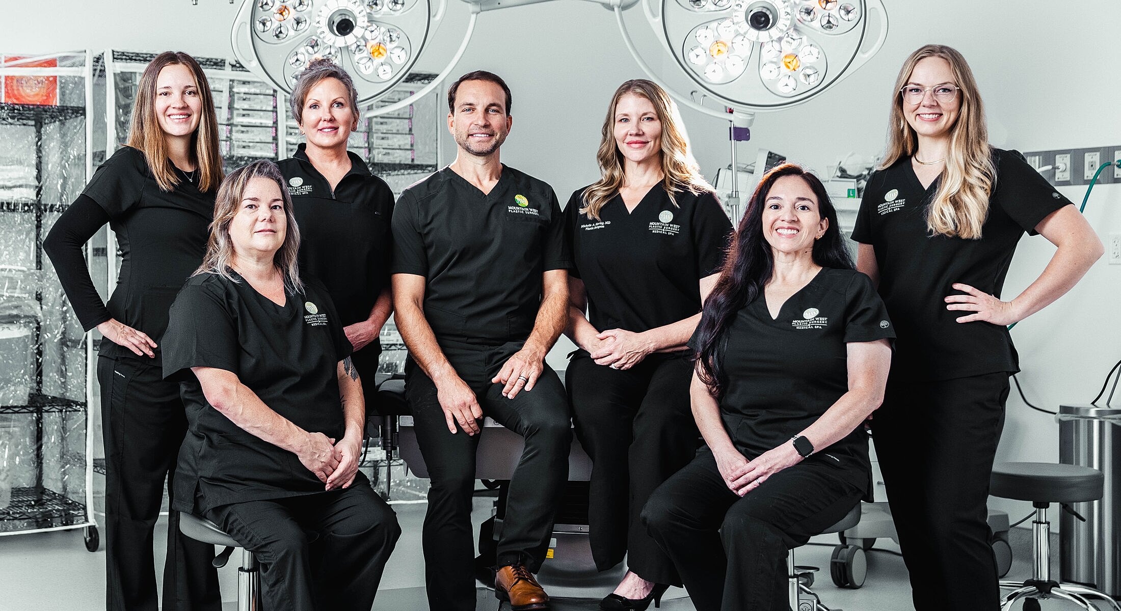 Medical team posing in surgical attire.