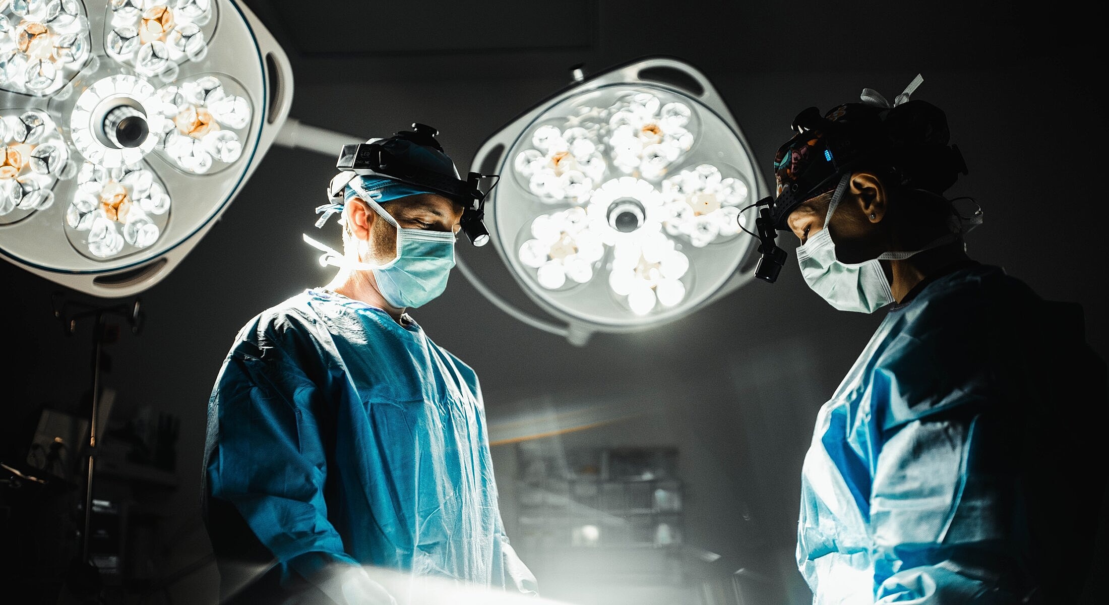 Surgeons performing surgery in operating room.