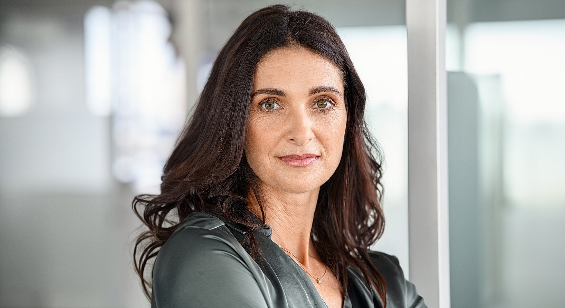 Woman with long hair in a professional setting.